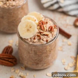 Delicious Banana Bread Overnight Oats in a clear jar, garnished with fresh banana slices and crunchy nuts, bringing the comfort of homemade banana bread to your breakfast.