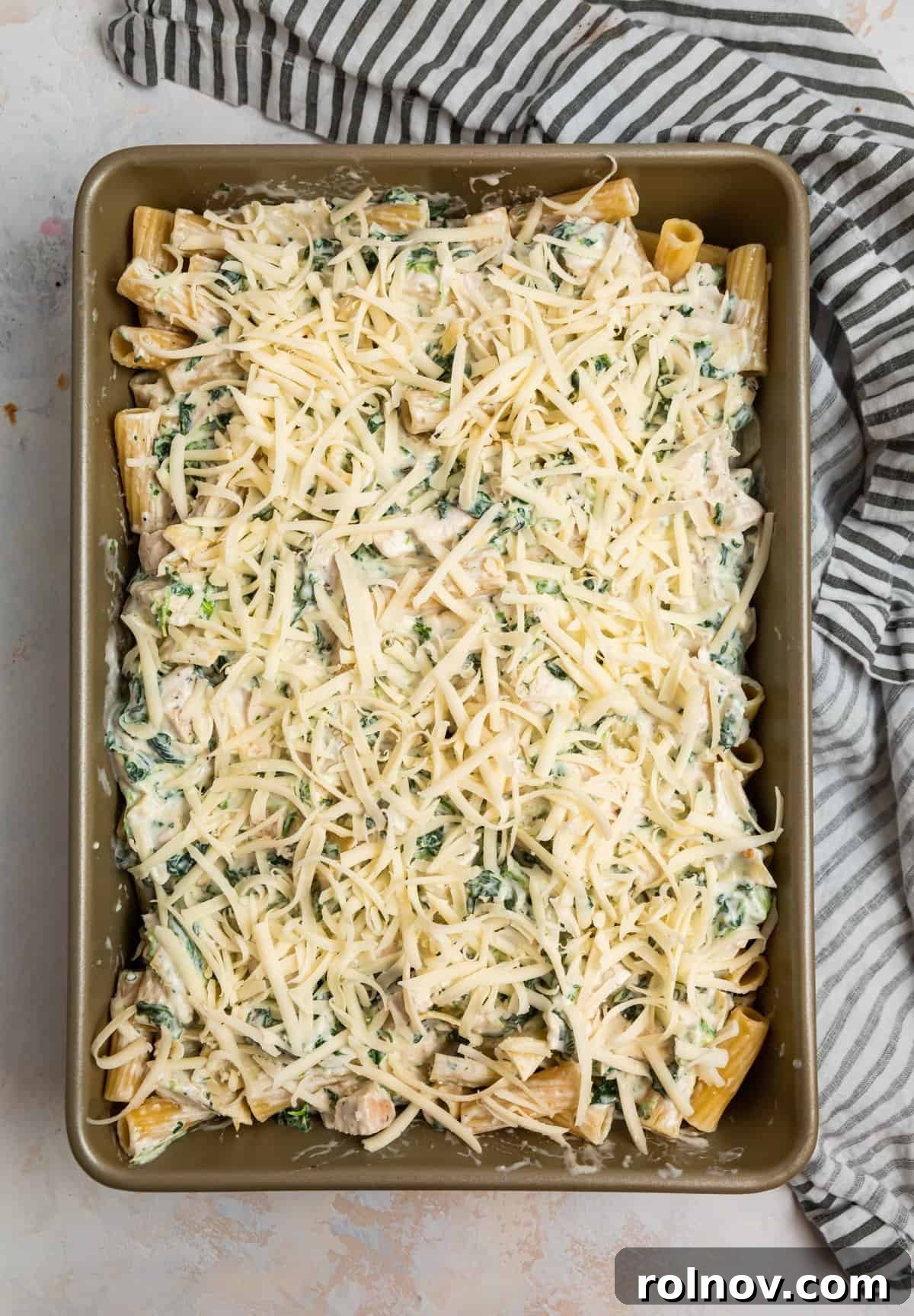 Casserole dish with shredded cheese on top.