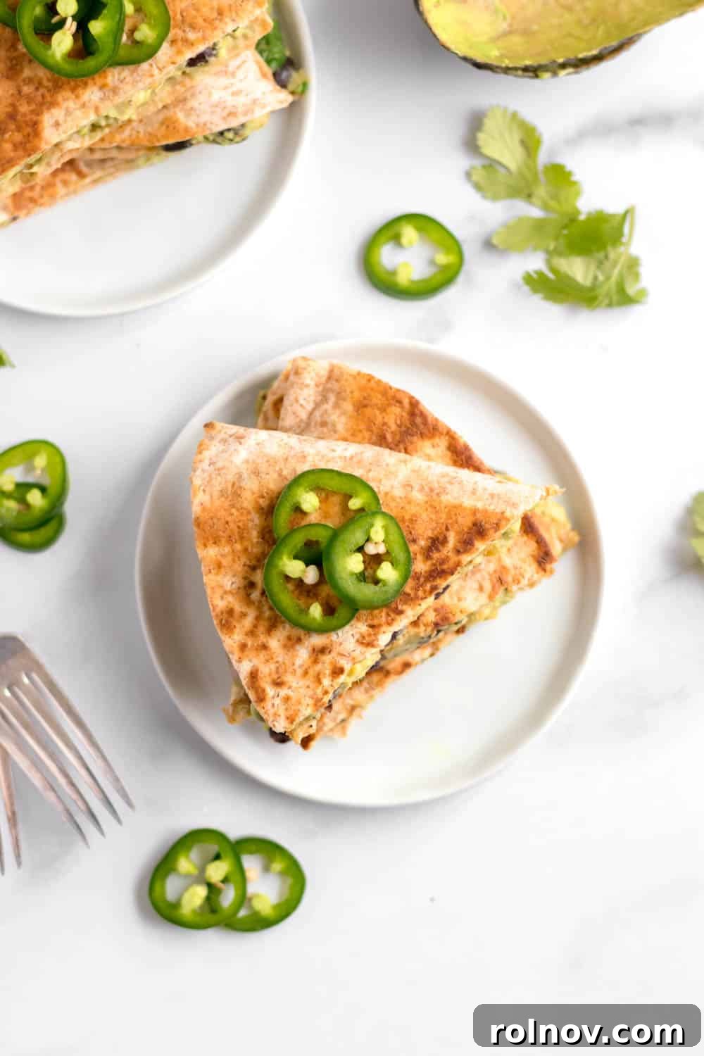 A stack of golden-brown vegan black bean quesadillas, perfectly cooked and ready to be enjoyed, showcasing a wholesome and satisfying plant-based meal.