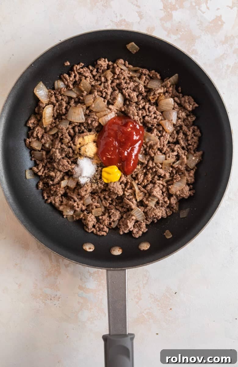 Cheesy Burger Potato Boats 8 Ground beef browned in skillet with ketchup, mustard and seasoning.