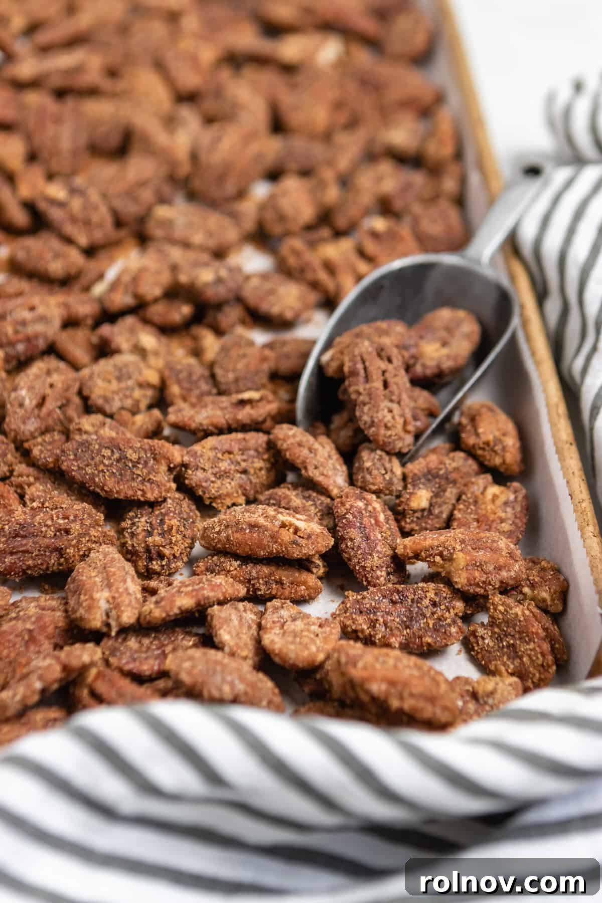 Crock Pot Pumpkin Spice Glazed Pecans 2 Sheet pan filled with golden-brown pumpkin spiced cinnamon pecans, ready to be enjoyed.