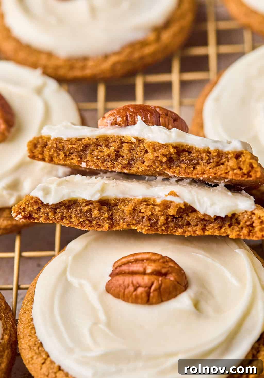 Golden Spiced Molasses Pumpkin Chews 16 Pumpkin cookies broken in half and stacked.