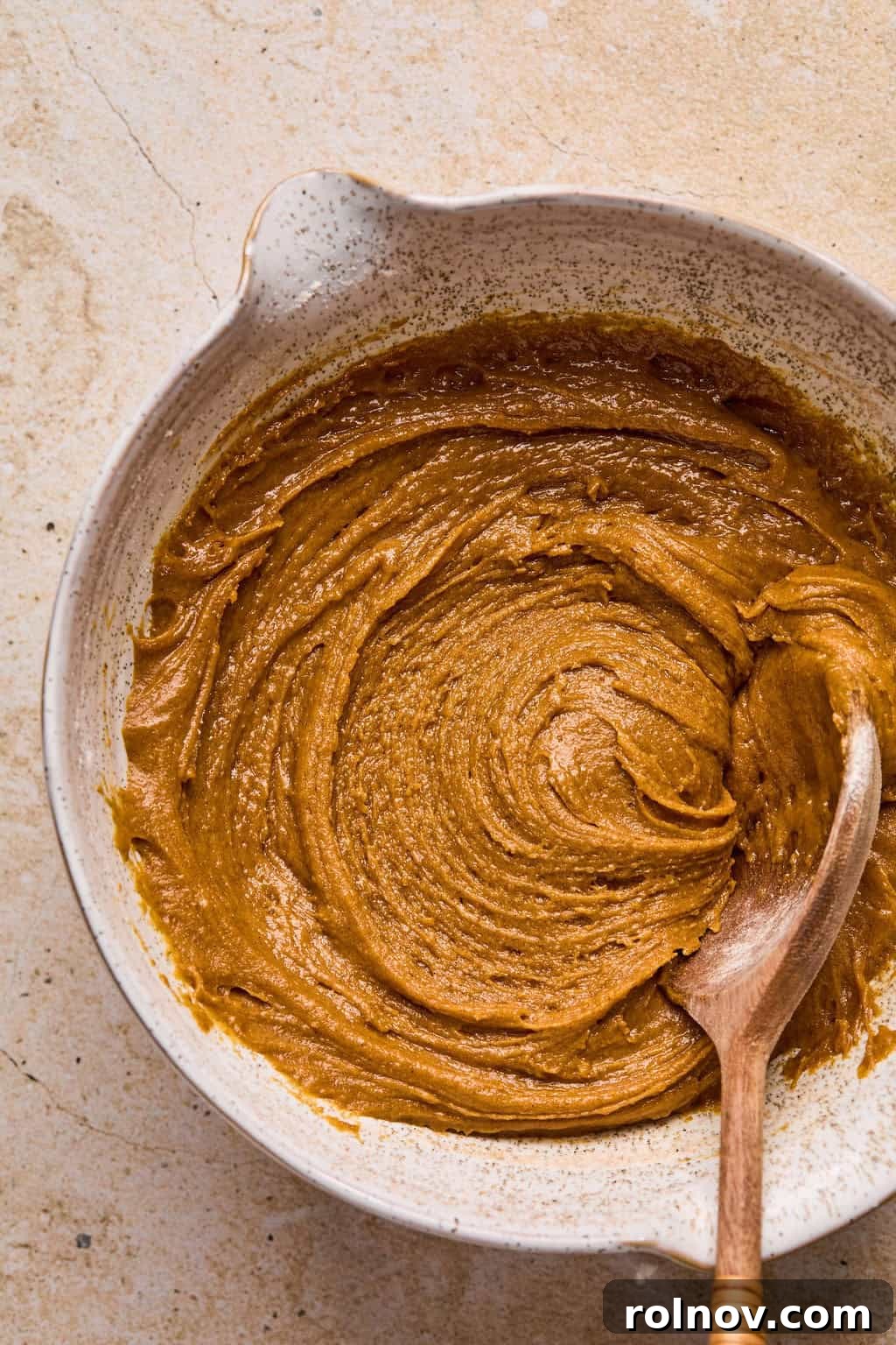 Golden Spiced Molasses Pumpkin Chews 8 Molasses cookie dough mixed in bowl with wooden spoon.