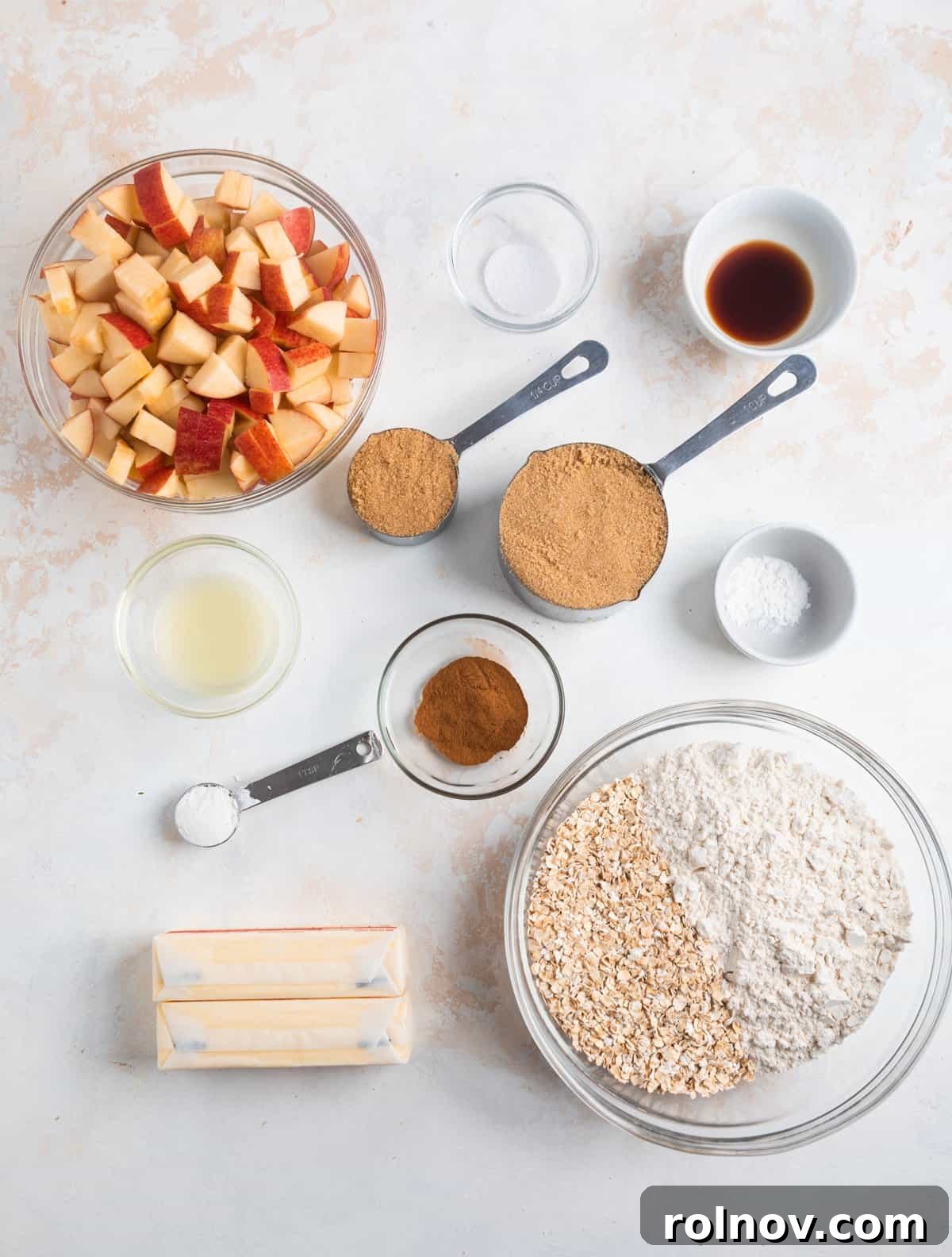 Golden Apple Crumble Bars 3 Assortment of ingredients including quick oats, flour, cinnamon, and melted butter laid out on a kitchen counter, ready for baking.