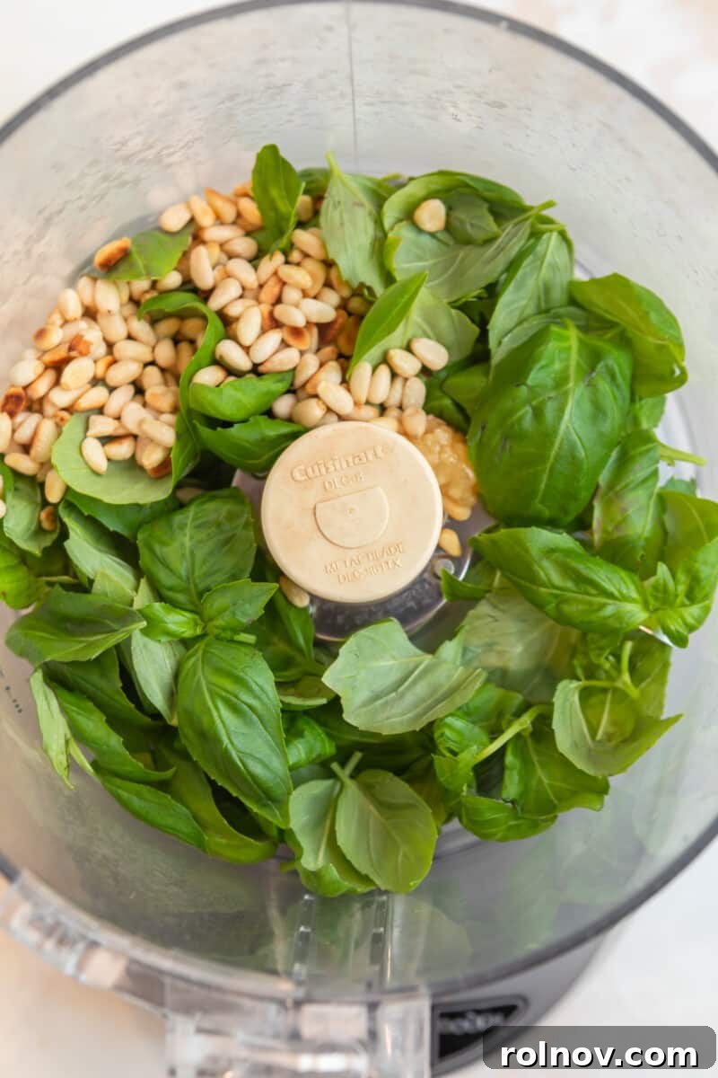 Emerald Orzo Pesto Salad 4 Basil, pine nuts, and garlic in food processor.