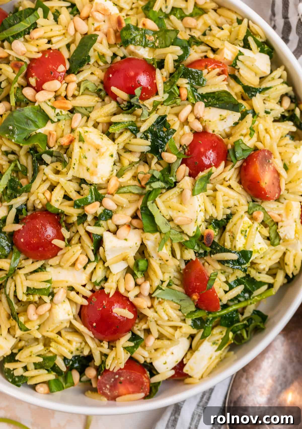 Emerald Orzo Pesto Salad 10 White serving bowl with orzo salad with pesto.