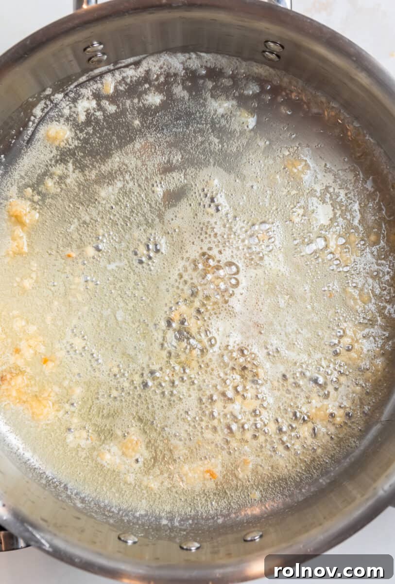 Golden Skillet Gnocchi 4 Melted butter and minced garlic simmering in a pan, releasing a fragrant aroma.