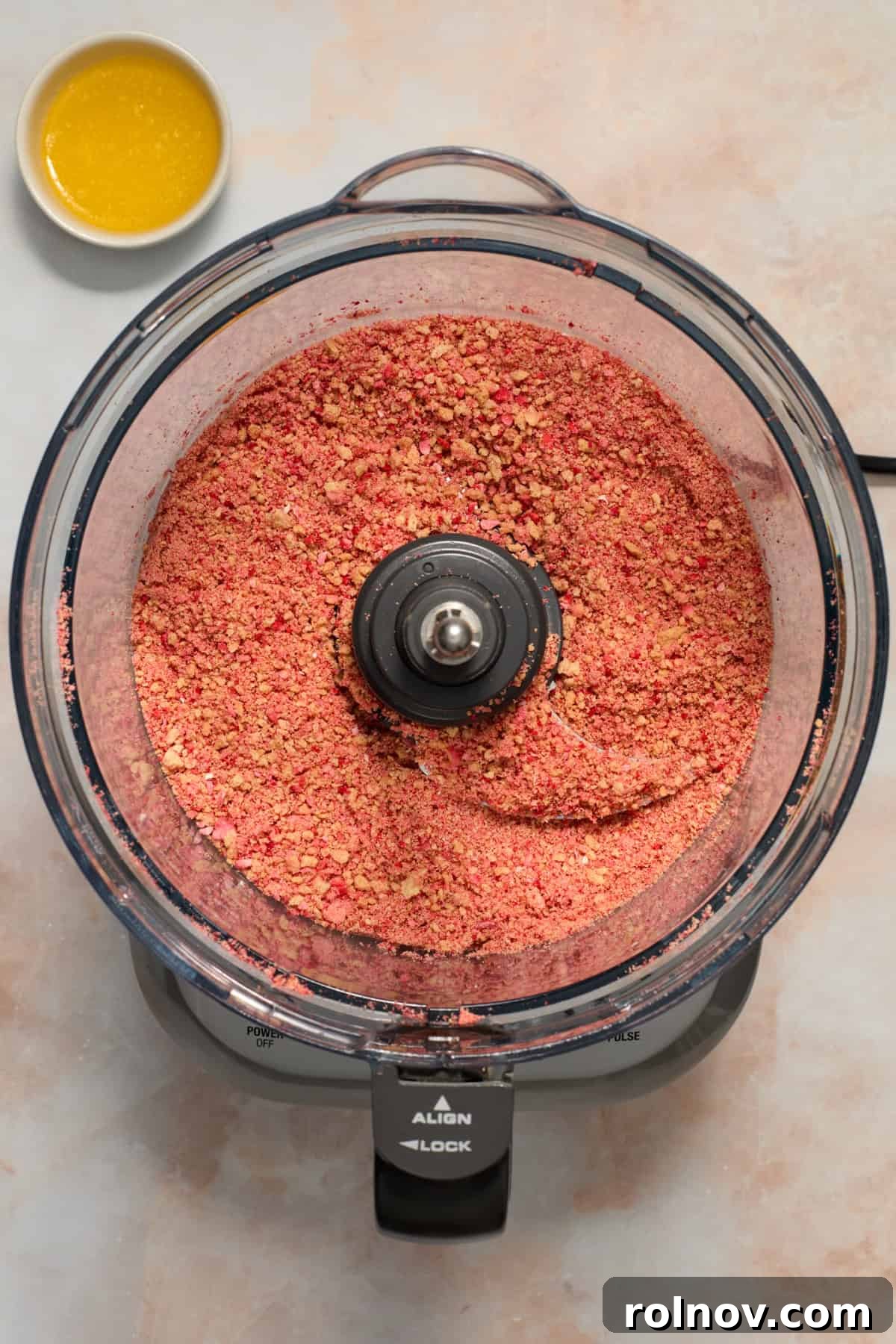 Berry Crunch Bliss Cupcakes 10 Crumbled Golden Oreos and freeze-dried strawberries in a food processor, ready to be blended.