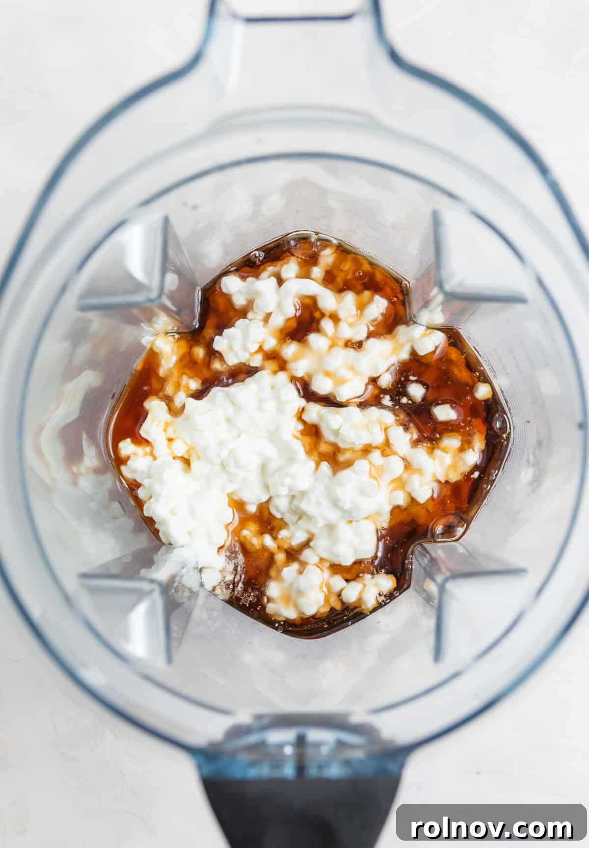 Cottage Cream Dream 9 Cottage cheese, maple syrup, vanilla, and sea salt being added to a Vitamix blender for the base mixture.