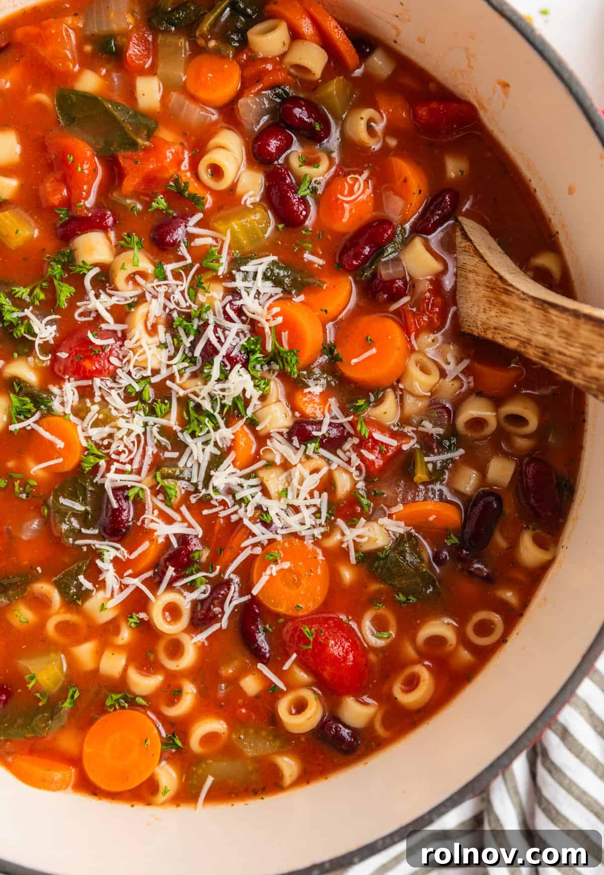 Rustic Italian Garden Vegetable Soup 3 Overhead shot of a Dutch oven filled with vegetable soup, with a ladle poised to scoop.