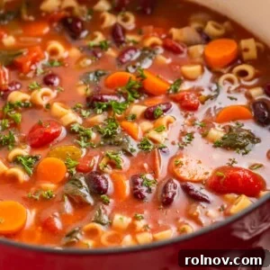 Rustic Italian Garden Vegetable Soup 8 Dutch oven with vegetable soup topped with chopped parsley.