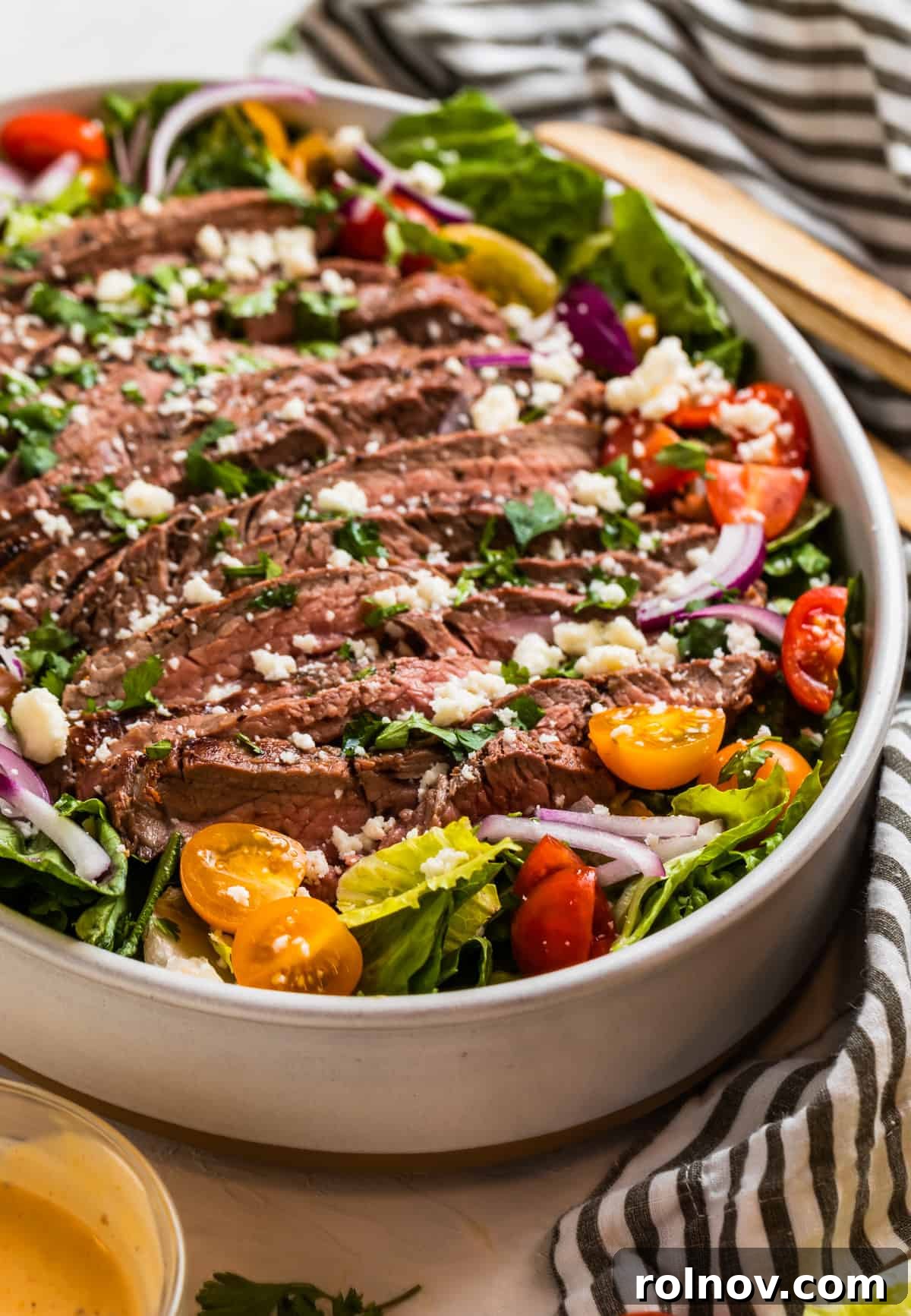 Powerhouse Flank Steak Salad 2 Grilled flank steak salad topped with chopped cilantro and cheese, ready to be served.