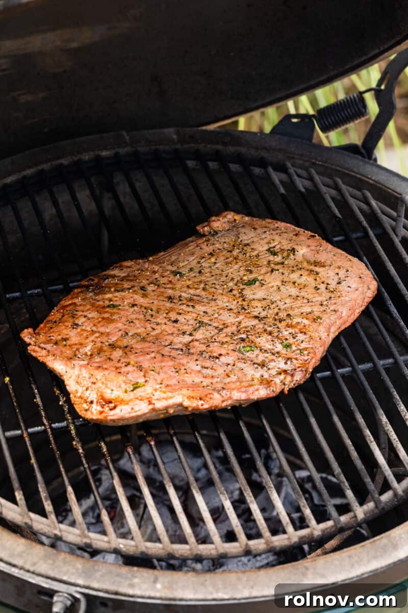 Powerhouse Flank Steak Salad 8 Flank steak grilling on a barbecue.