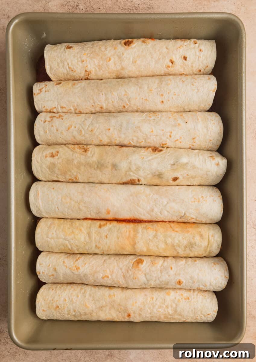 Pan with prepped enchiladas before baking.