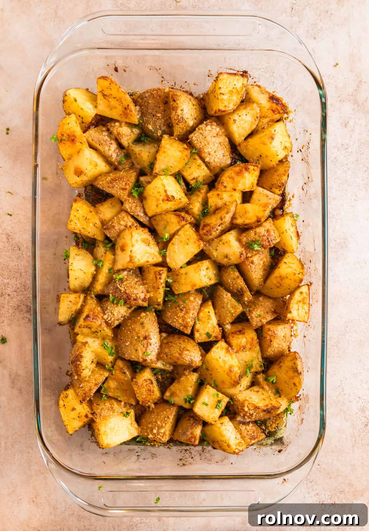 Crispy Parmesan Roasted Potatoes 7 Roasted parmesan crusted potatoes in glass pan.