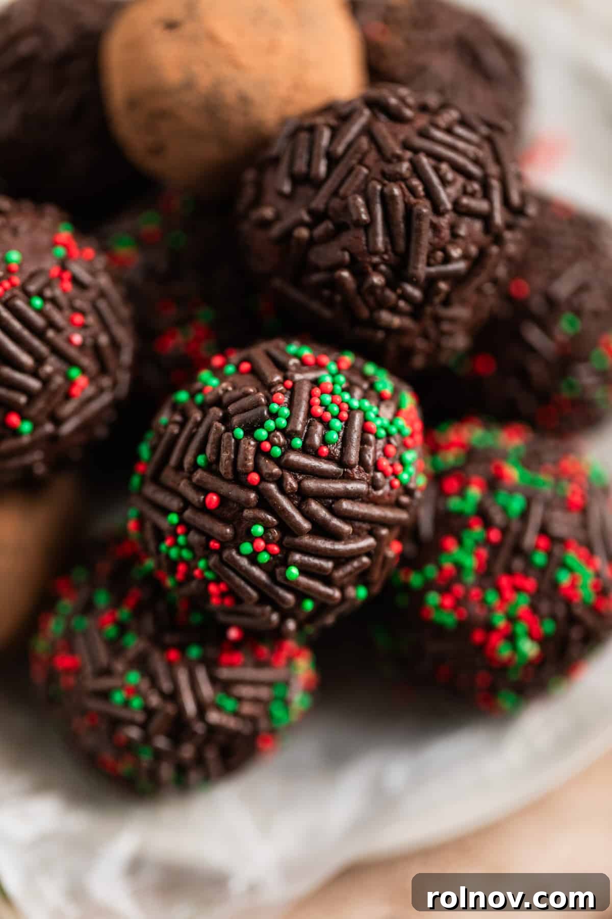 Effortless 5 Ingredient Amaretto Truffles 2 Overhead view of amaretto truffles coated in festive sprinkles on a serving dish.