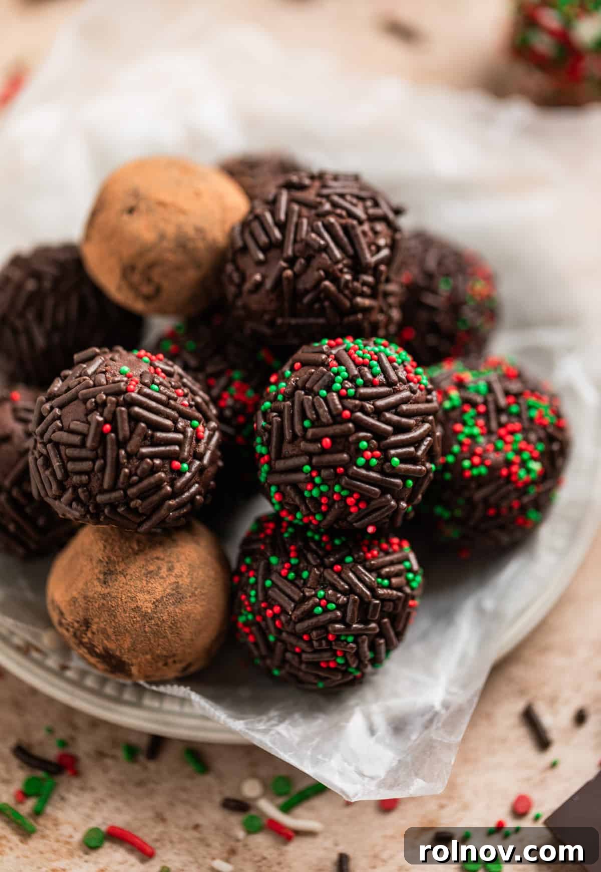 Effortless 5 Ingredient Amaretto Truffles 11 Tray with variety of cocoa dusted and sprinkle covered chocolate truffles.