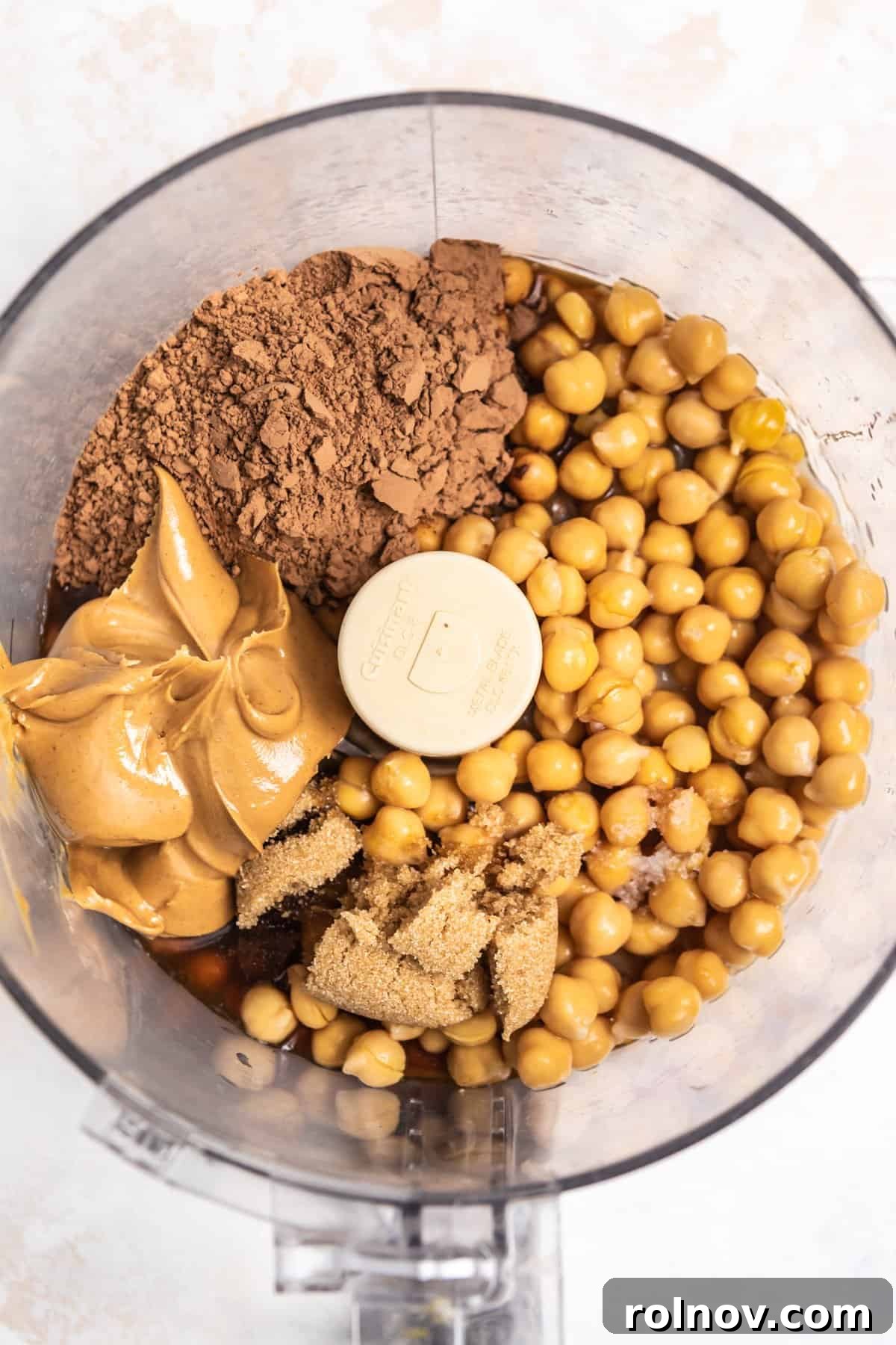 Garbanzo beans, cocoa powder, peanut butter, maple and other ingredients in food processor.