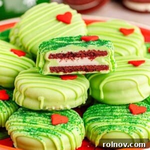 Red velvet Oreos dipped in vibrant green candy coating and decorated with a tiny candy heart.