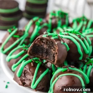 Mint chocolate truffles coated in dark chocolate with a festive green drizzle on top.