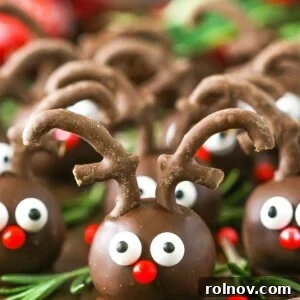 Charming Reindeer Cookie Balls with pretzel antlers and candy eyes.