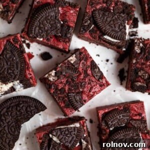 An overhead view of decadent Red Velvet Fudge with Oreos, surrounded by whole Oreo cookies.