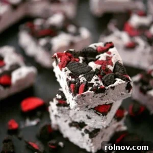 Creamy white chocolate fudge adorned with red icing-filled Oreos.