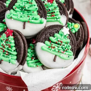 Chocolate sandwich cookies with Christmas trees iced onto each, adorned with festive sprinkles.