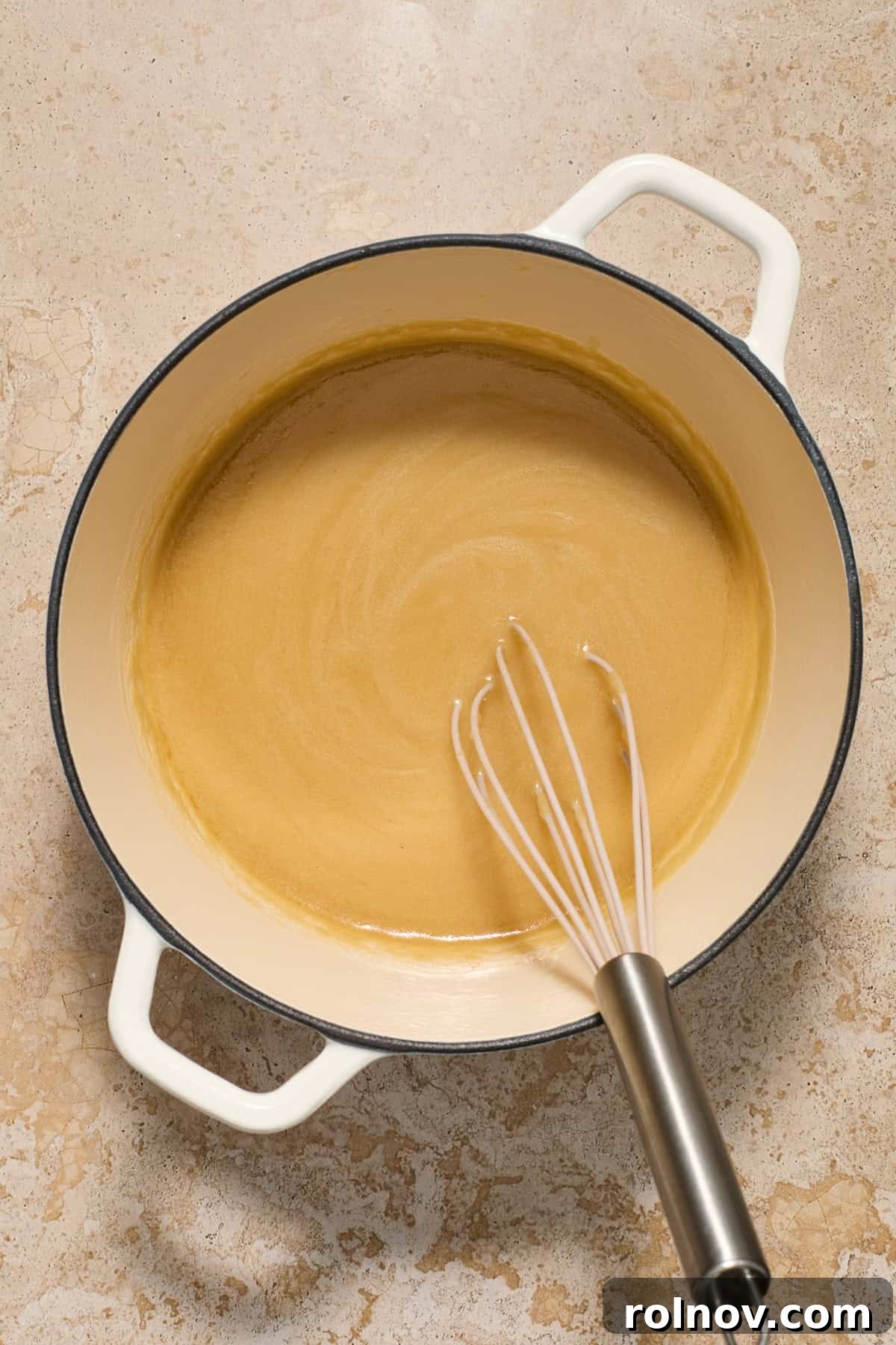 Turkey gravy made in pot with whisk.