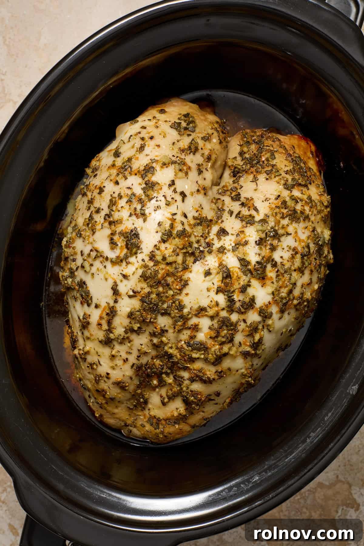 Cooked slow cooker turkey breast in pot.