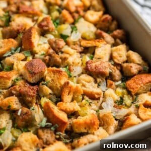 Classic Turkey Sausage Dressing 17 Turkey sausage sourdough bread stuffing in pan with fresh herbs on top, ready to be served.