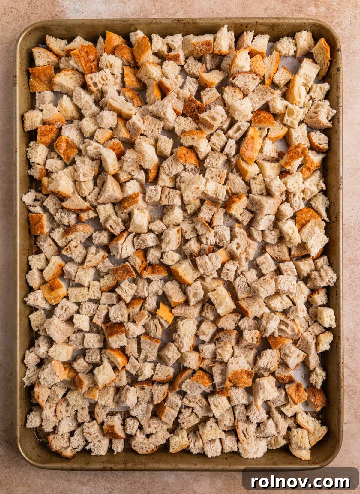 Classic Turkey Sausage Dressing 5 Cubed sourdough bread drying on a baking sheet.