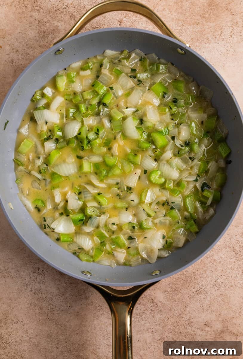Classic Turkey Sausage Dressing 10 Skillet containing butter, onions, celery, and a fragrant herb mixture.