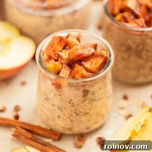 Apple overnight oats in jar topped with cinnamon apples.