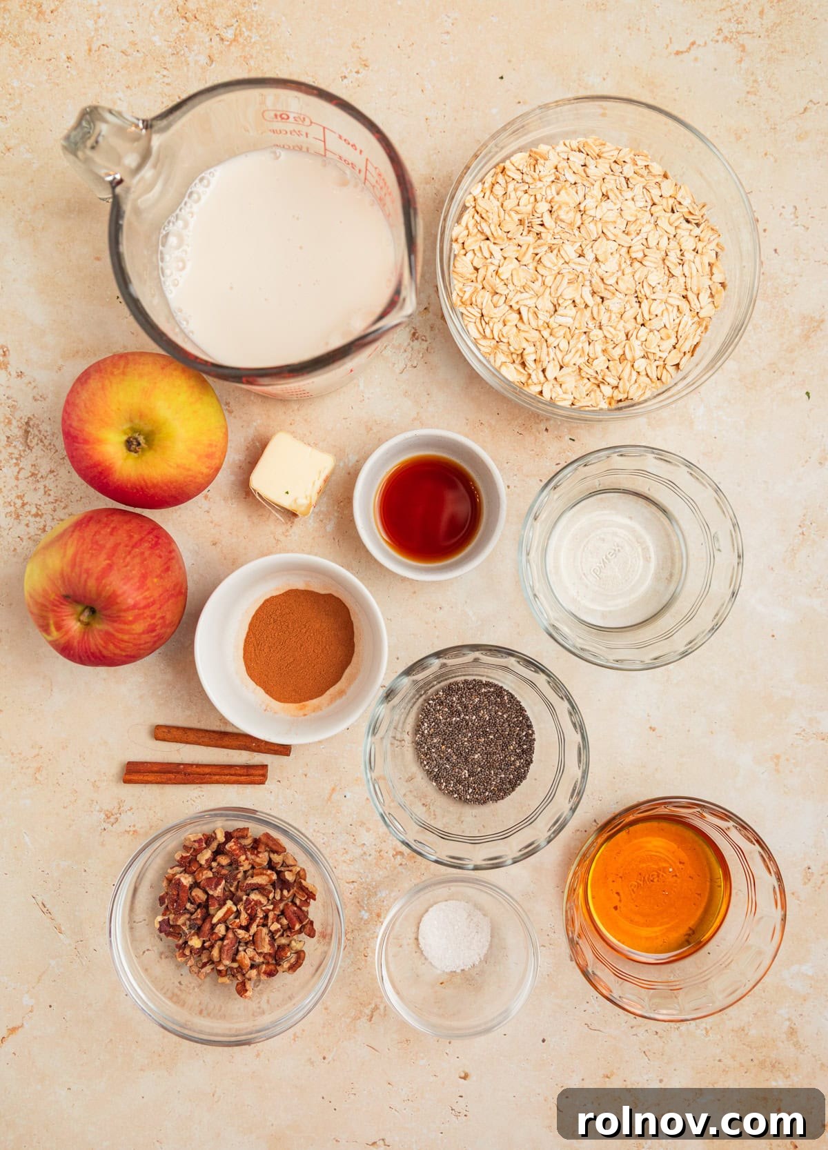 Apple Pie Overnight Oats 4 Fresh apples, milk, maple syrup, rolled oats, and other key ingredients beautifully arranged for the recipe.