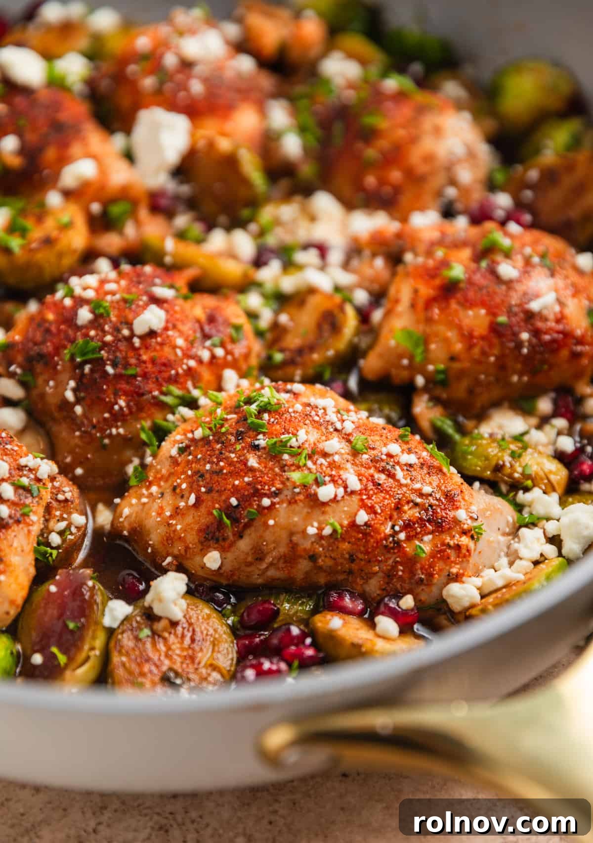 Sheet Pan Golden Chicken and Roasted Brussels Sprouts 2 Balsamic dijon chicken thighs in skillet with brussel sprouts, goat cheese, pomegranate arils etc.