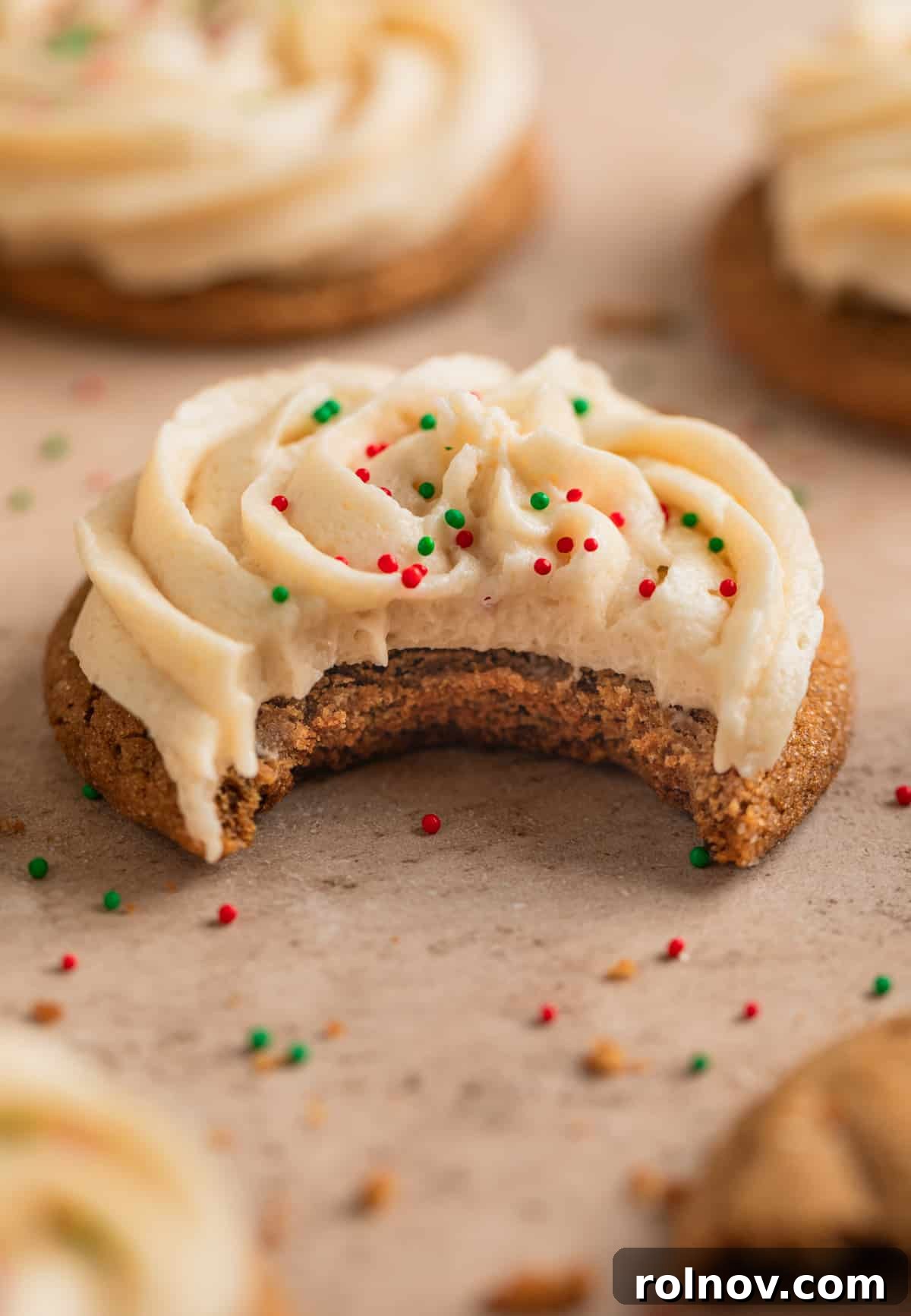 Ginger Cloud Cookies 3 Bite taken out of cookie with icing on top.