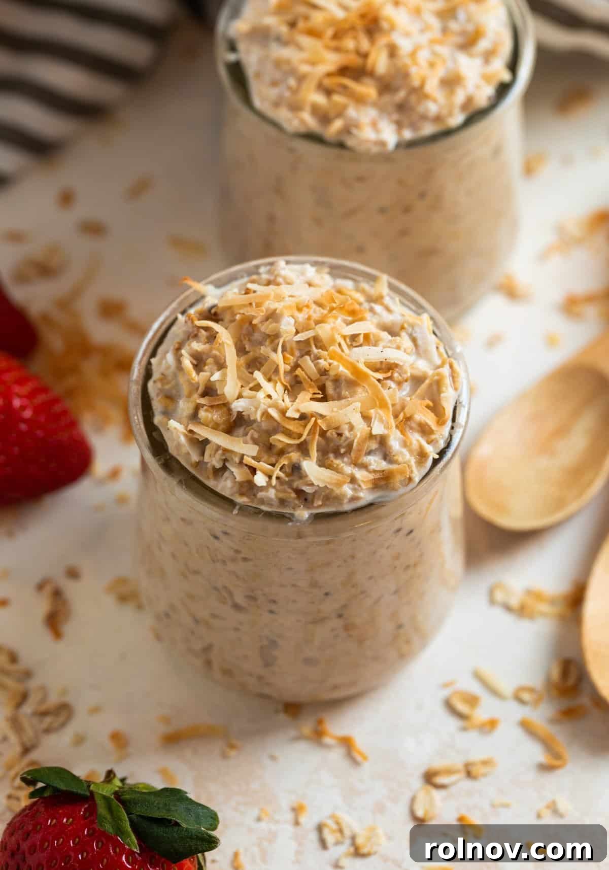 Jars with coconut overnight oats topped with toasted coconut.