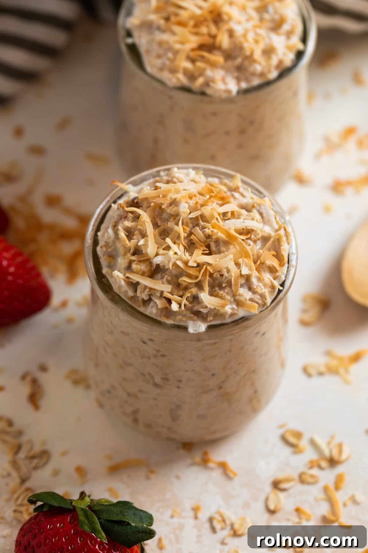 Jar of overnight oatmeal with coconut shredded over top.