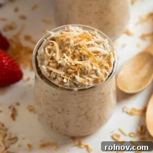 Coconut cream pie overnight oatmeal in a jar topped with toasted coconut.