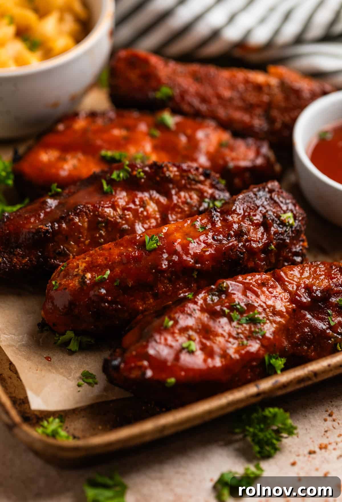 Crispy Air Fryer Country Ribs 2 Air fryer country style ribs with BBQ sauce on parchment lined tray.