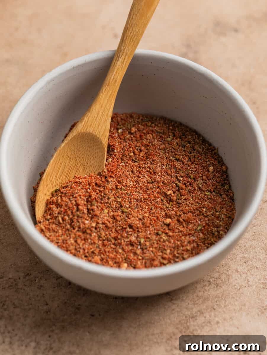 Crispy Air Fryer Country Ribs 4 Dry rub in bowl with small wooden spoon.