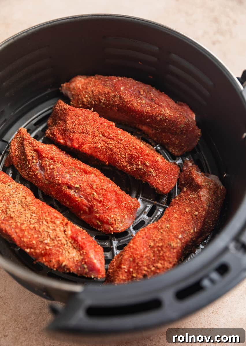 Crispy Air Fryer Country Ribs 7 Country style ribs with dry rub in oiled air fryer basket.