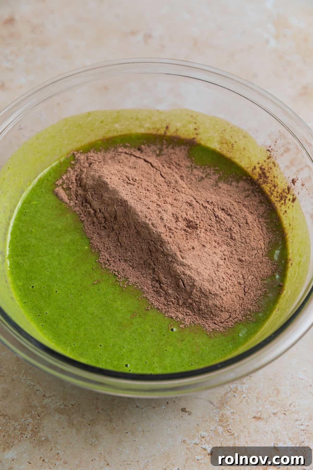 Emerald Chocolate Muffins 9 Dry ingredients added to wet ingredients in mixing bowl.