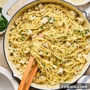 Pot with chicken Alfredo topped with parsley.