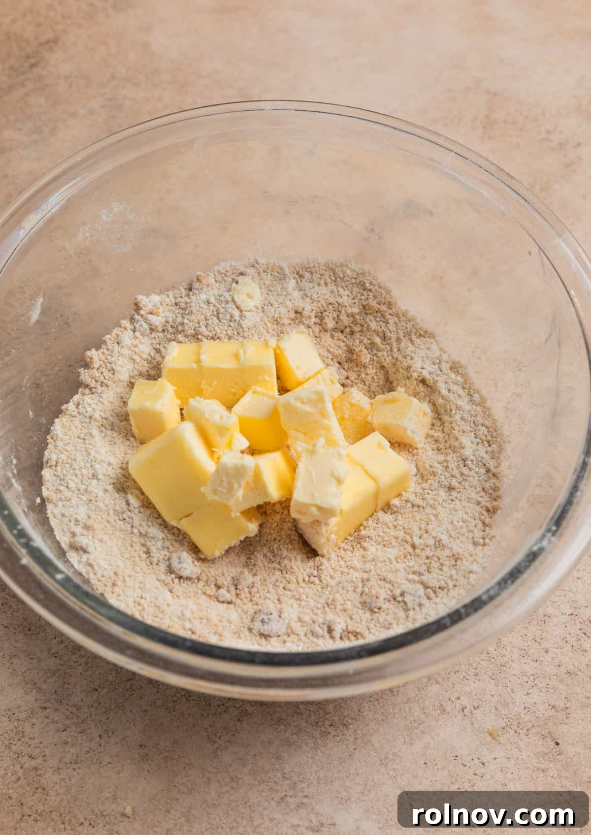 Bright and Zesty Blueberry Lemon Coffee Cake 13 Cubed butter in glass bowl with flour and brown sugar mixture.