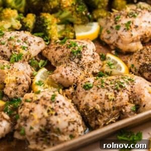 Lemon chicken on sheet pan topped with chopped parsely.