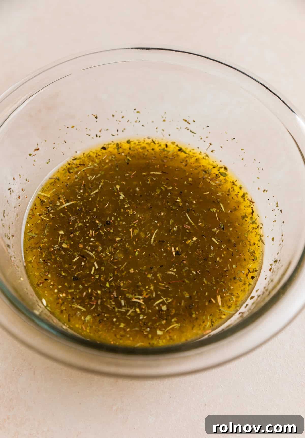 Bowl with lemon chicken marinade.