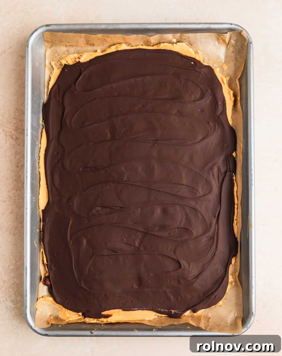 Frozen Greek Yogurt Bites 8 Frozen peanut butter dark chocolate Greek yogurt bark on a sheet pan, perfectly solidified and ready for the next step.