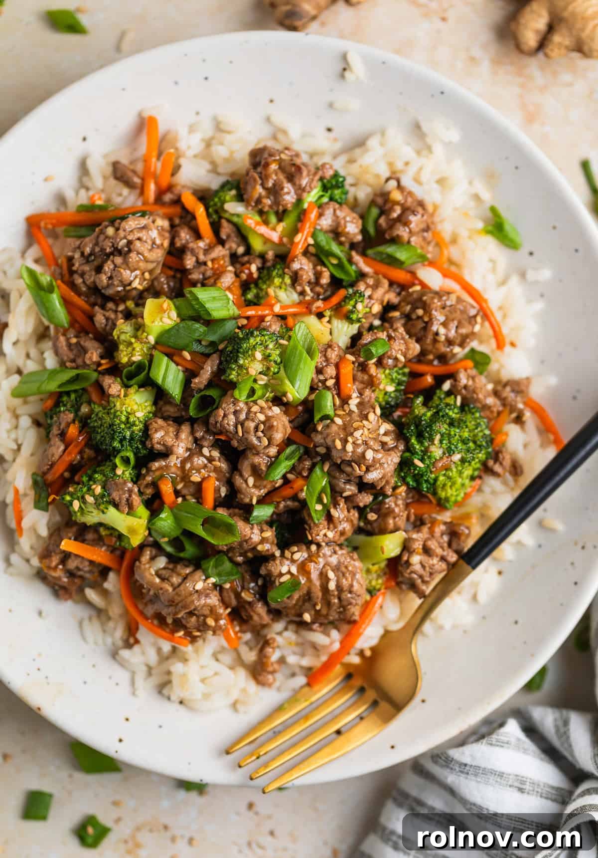 Sticky Teriyaki Ground Beef 2 Plate with ground beef teriyaki with broccoli and carrots served over rice and topped with sesame seeds.
